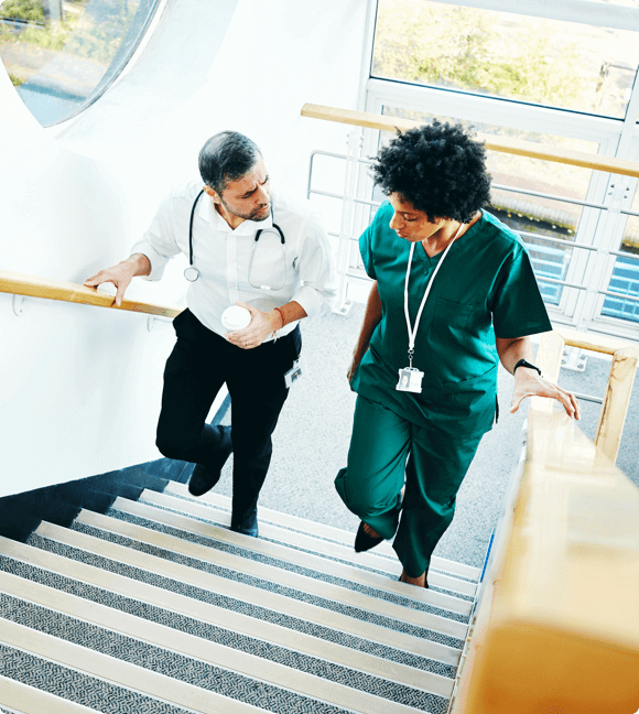 Medical professionals walking upstairs - HealthStream Performance &amp; Engagement